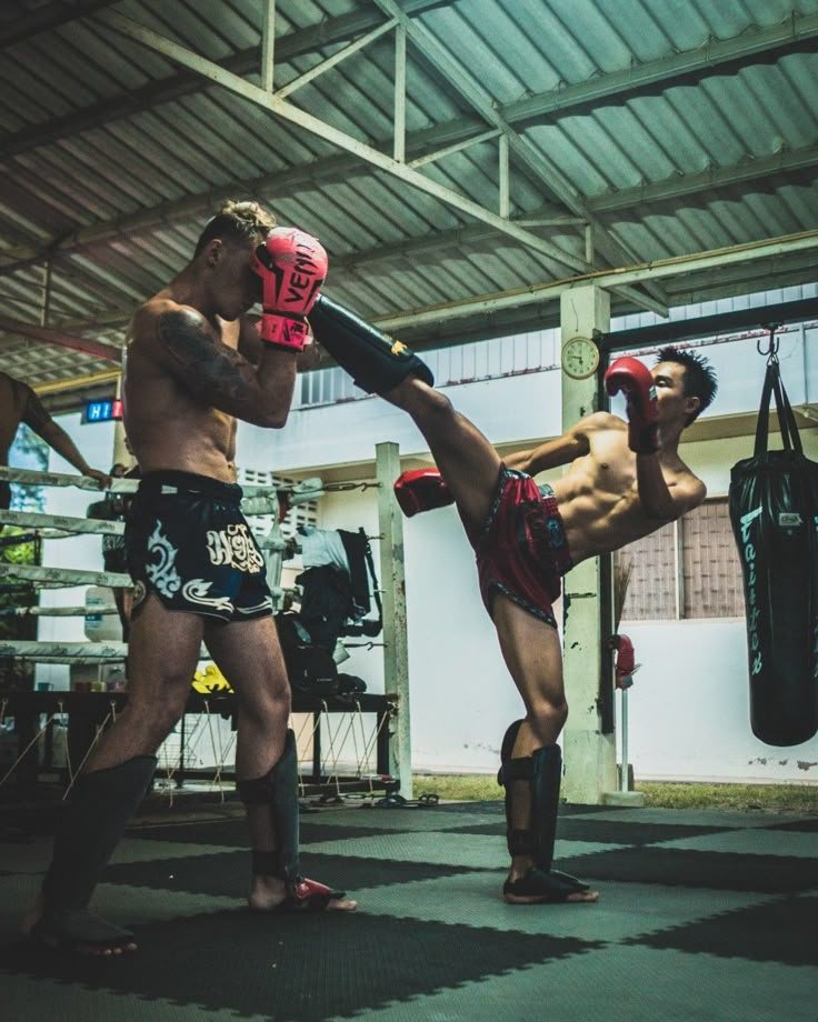 A student working pads with a coach at Clinch Muay Thai